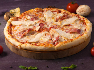 pizza with chicken, bacon and cheese on a wooden Board