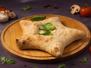 pizza with mozzarella cheese in the shape of a star on a wooden Board