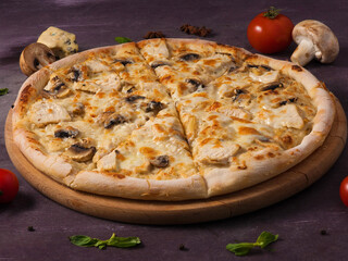 pizza with chicken and mushrooms on a wooden Board