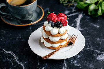 Gingerbread cake on a plate next to a cup of coffee