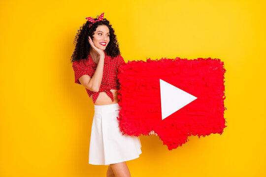 Photo of cute optimistic brunette hair lady hold look pinata wear red top skirt isolated on yellow color background