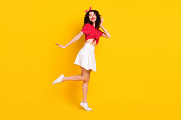 Full size profile photo of optimistic nice brunette lady look empty space wear shirt band isolated on yellow background