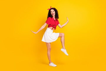 Fototapeta na wymiar Full size photo of cute optimistic brunette hair lady dance wear red top skirt isolated on yellow color background