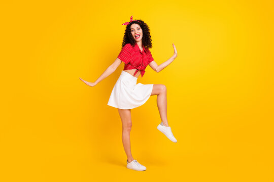 Full size photo of cute optimistic brunette hair lady dance wear red top skirt isolated on yellow color background