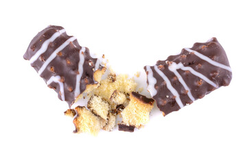 Broken chocolate chip cookies. Pieces and crumbs of a chocolate stick or bar are isolated on a white background . Top View.