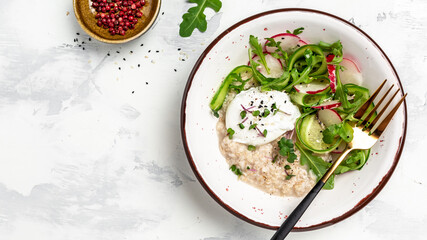oatmeal porridge breakfast with poached egg and fresh vegetables. Healthy balanced food. Long banner format, top view