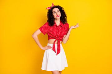 Photo of cute optimistic brunette hair lady look empty space wear red top skirt isolated on yellow color background