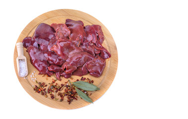 raw chicken or goose liver with spices on a round wooden cutting board close-up isolated on a white background.top view