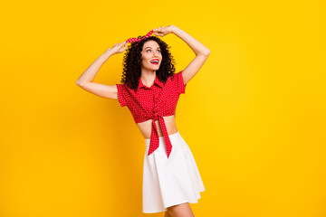 Photo of optimistic nice brunette lady look empty space wear shirt band isolated on yellow color background