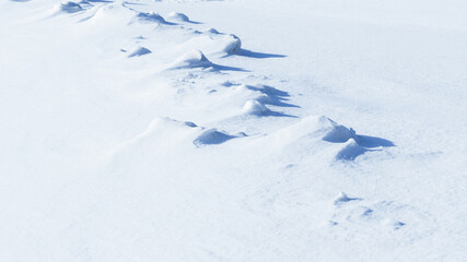 shadows and textures on white snow in winter