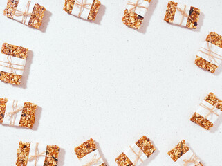 Granola bar and ingredients on a white stone table.Top view. Copy space.