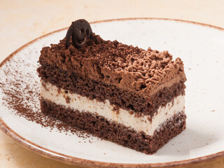 praline cake on a light plate decorated with cocoa powder