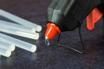 Close-up of a thermo gun with glue sticks - obrazy, fototapety, plakaty