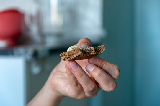 Hand with bread. Diet in hospital. Woman hand holding a piece of bread. Vegan keto diet. Healthy