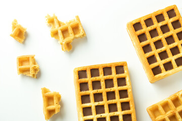 Waffles, chocolate in a waffle on a white background, square waffles top view, pattern