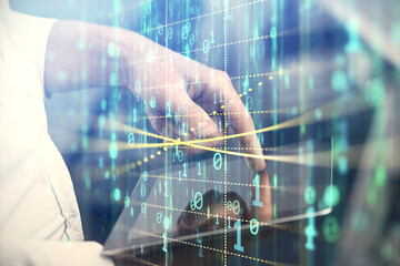 Double exposure of man's hand holding and using a digital device and data theme hologram drawing. Technology concept.