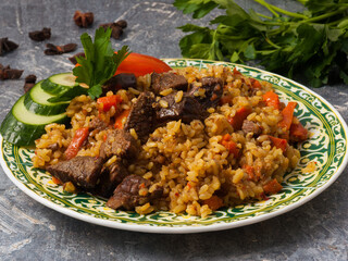 pilaf with beef on a gray background. Close up