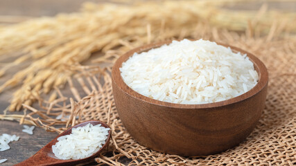Thai jasmine rice on wood background top view and copy space, organic rice, and healthy food