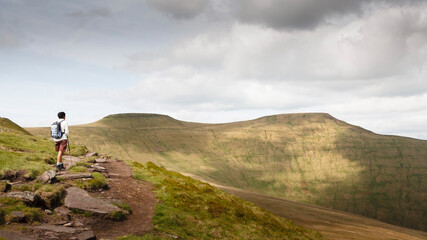 Asian Indian woman hiking, Pen y Fan, Brecon Beacons, Wales UK