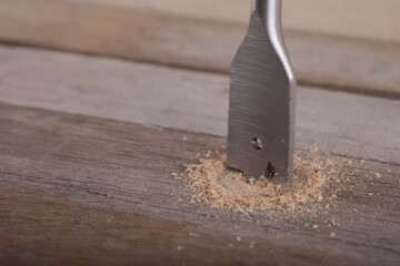 Feather wood drill bit on wooden background. Drill bit for wood on natural wood background....