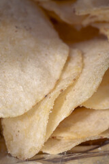 Potato chips in a bundle close up. Crispy Potato chips to eat from bag as snack with calories and cholesterol crisp closeup.