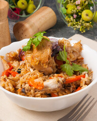 pilaf with chicken decorated with parsley. close up