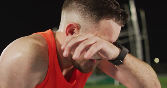 Tired caucasian male athlete, sweating and suffering from exhaustion