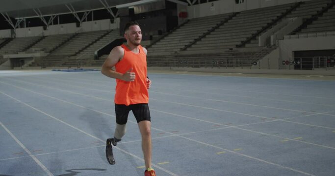 Caucasian disabled male athlete with prosthetic leg training, running