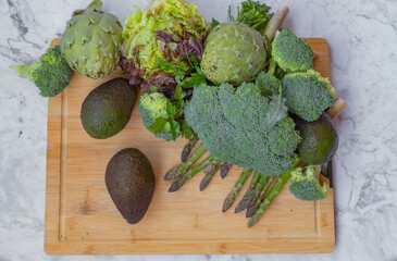 Dark green leafy fresh green vegetables on cutting board