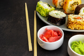 Sushi rolls of different types of homemade in a close-up on a dark background