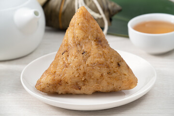 Zongzi. Rice dumpling for Dragon Boat Festival on bright wooden table background.