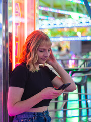Mujer joven usando su móvil en la feria