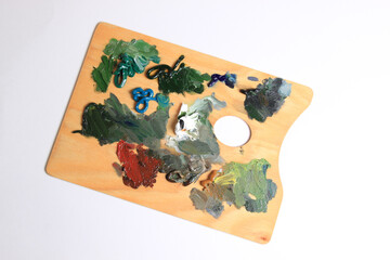 The artist's palette. Close-up Of An Art Palette Top view of a colorful palette with colorful mixed colors. oil paints