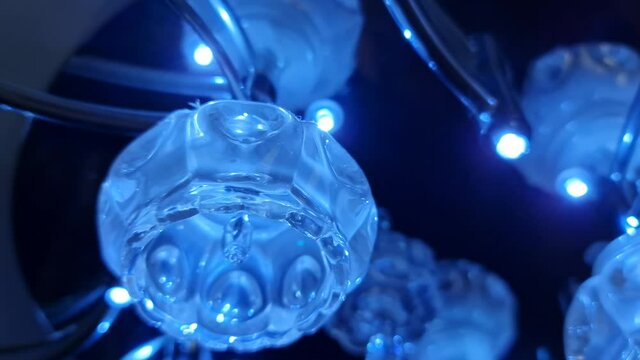 Blue chandelier. Blue light bulbs. Glass blue chandelier.
