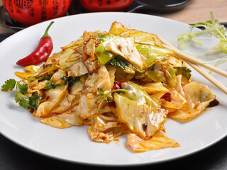 Chinese spicy fried cabbage on a white plate
