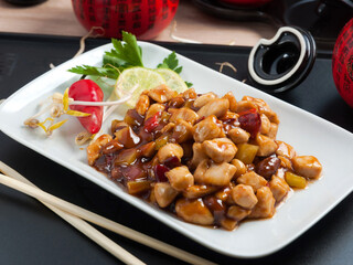 kung PAO chicken with peanuts on a white plate
