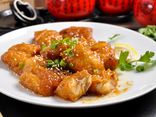 cod in honey sauce on a white plate. Chinese cuisine