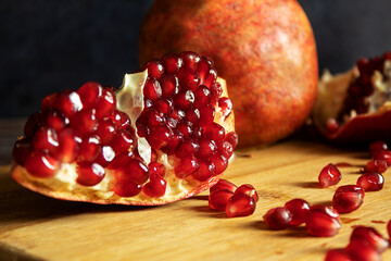 Red ripe pomegranate, in a dramatic style, on a dark background, on a chalkboard, still life