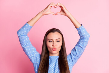 Fototapeta na wymiar Photo portrait of cheerful brunette girlfriend showing heart sending air kiss pouted lips isolated on pink pastel color background