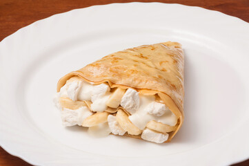 crepe with marshmallows, banana and whipped cream