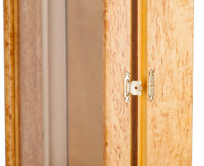 Opened golden castle with an ornament on a wooden frame with glass for a picture or photo