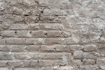 Half-finished cement plastered brick wall. Texture background wallpaper.