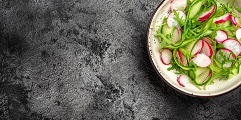 Vegetable salad with radish, cucumbers and arugula. Concept for a tasty and healthy meal. Long banner format, top view