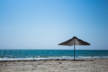 Sea summer beach panorama view with wooden umbrella Black sea