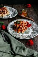 waffles with honey on a wooden background