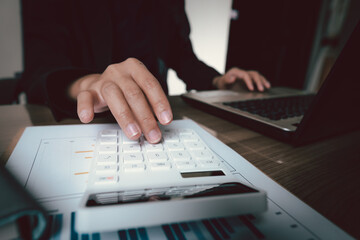 Fototapeta premium bookkeeper or financial inspector hands making report, calculating or checking balance. Home finances, investment, economy, saving money or insurance concept