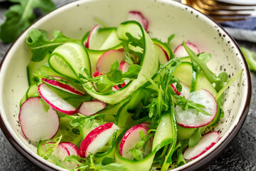 Vegan vegetarian background. Vegetable salad of radish, cucumber and arugula. Healthy eating concept. Detox diet plan. Weight loss. Cleanse program