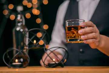 Barman pouring whiskey whiskey glass beautiful night there is a beautiful bokeh on background