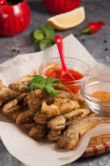 Chinese cuisine: small deep-fried fish. Vertical frame