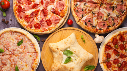 assorted pizzas on a wooden table. top view